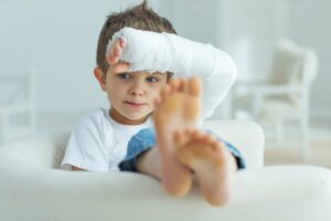 Injured child with plaster on arm